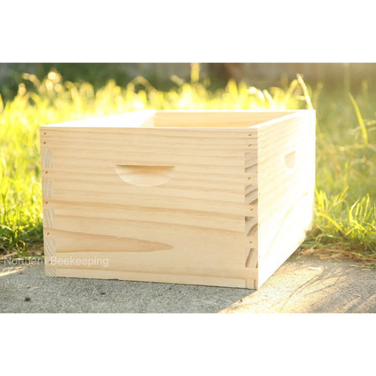 Wooden beehive box on a grassy background