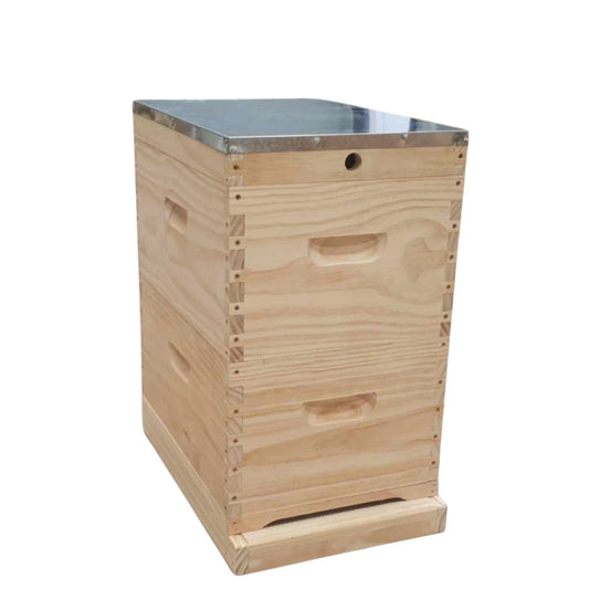 Wooden beehive box with metal top on a white background