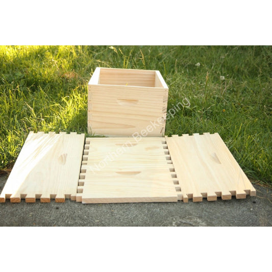 Wooden puzzle mat and box on grass